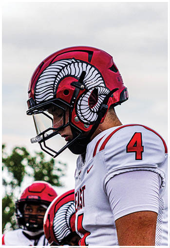A group of football players celebrating a touchdown. Description generated by AI