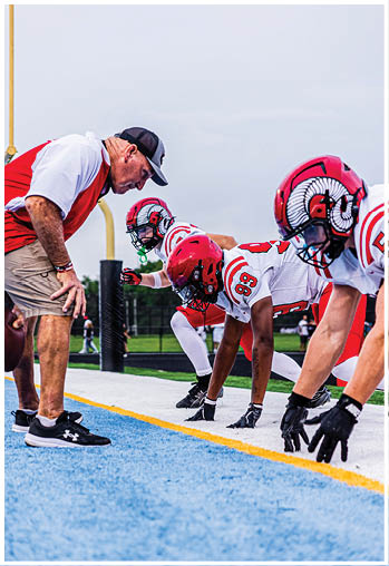 A group of football players celebrating a touchdown. Description generated by AI