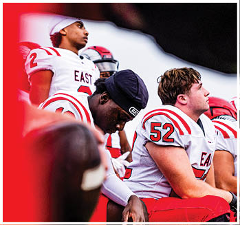 A group of football players celebrating a touchdown. Description generated by AI