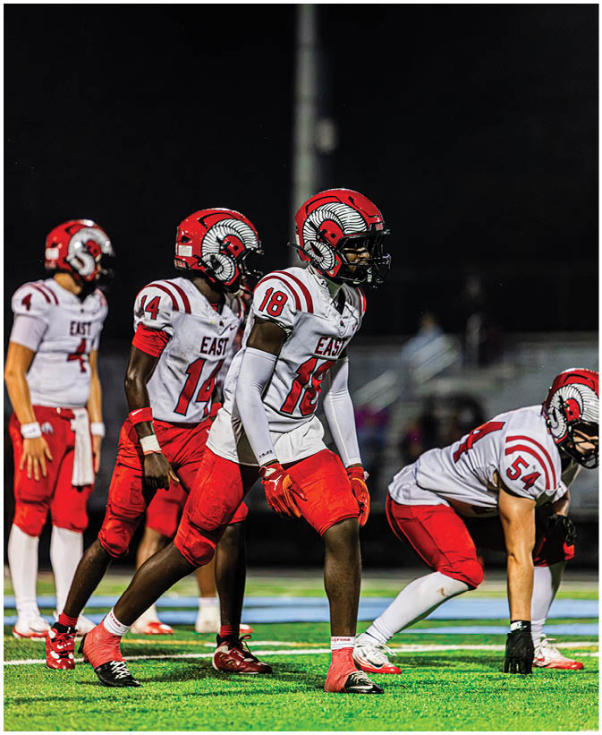 A group of football players on a field. Description generated by AI