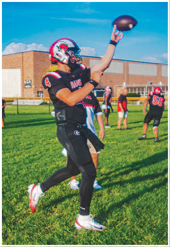 A group of football players celebrating a touchdown. Description generated by AI