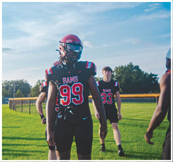 A group of football players celebrating a touchdown. Description generated by AI