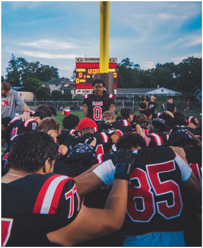 A group of football players on a field. Description generated by AI