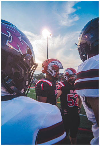 A group of football players celebrating a touchdown. Description generated by AI