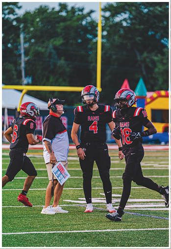A group of football players celebrating a touchdown. Description generated by AI