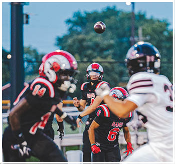 A group of football players celebrating a touchdown. Description generated by AI