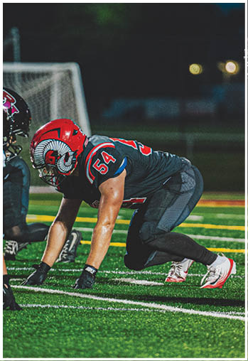 A group of football players celebrating a touchdown. Description generated by AI