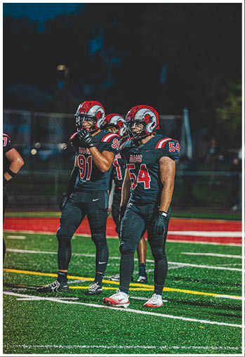 A group of football players celebrating a touchdown. Description generated by AI