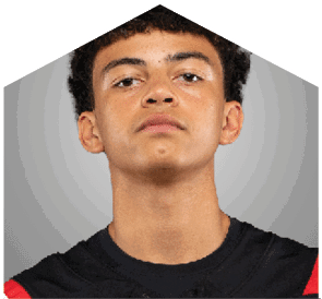 A young man wearing a white jersey with the number 10 on it. Description generated by AI