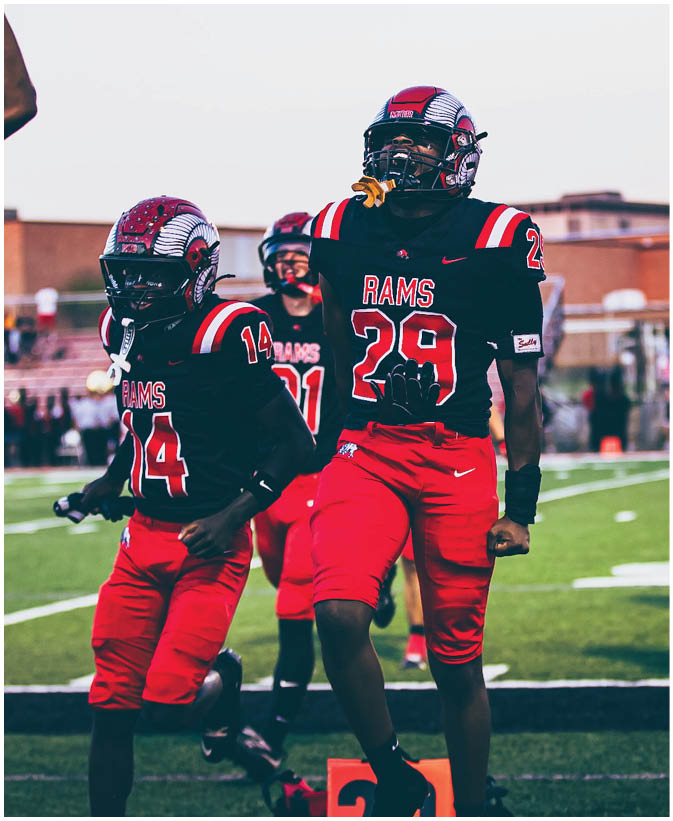 A group of football players on a field. Description generated by AI
