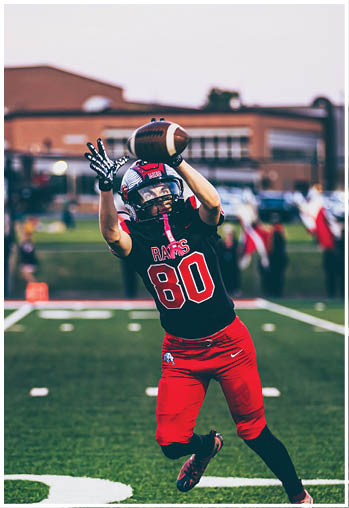 A group of football players celebrating a touchdown. Description generated by AI