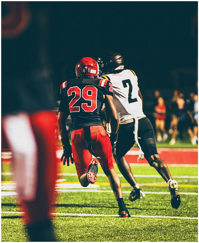 A group of football players on a field. Description generated by AI