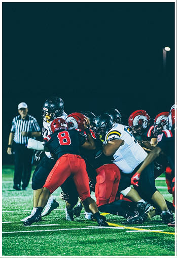 A group of football players celebrating a touchdown. Description generated by AI