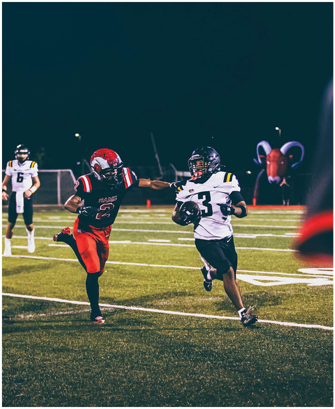 A group of football players on a field. Description generated by AI