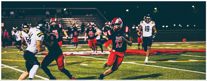 A group of football players on a field. Description generated by AI