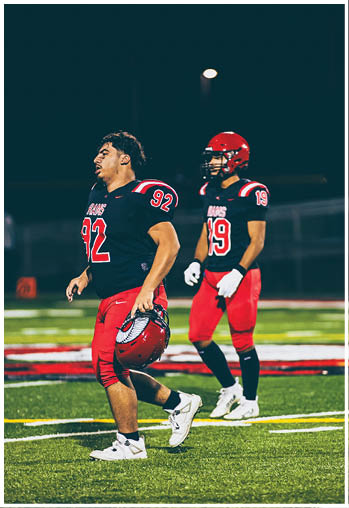 A group of football players celebrating a touchdown. Description generated by AI