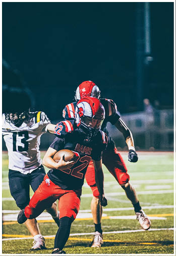 A group of football players celebrating a touchdown. Description generated by AI