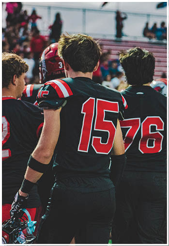 A group of football players celebrating a touchdown. Description generated by AI
