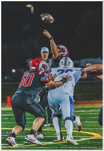 A group of football players celebrating a touchdown. Description generated by AI