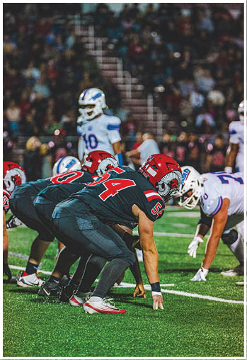 A group of football players celebrating a touchdown. Description generated by AI