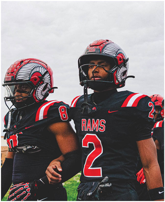 A group of football players on a field. Description generated by AI