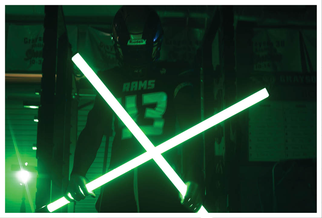 Two football players wearing black jerseys with the word Vista on them. Description generated by AI