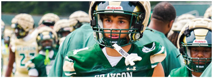 A football player wearing a blue and white uniform. Description generated by AI