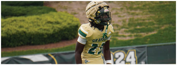 A football player wearing a blue and white uniform. Description generated by AI