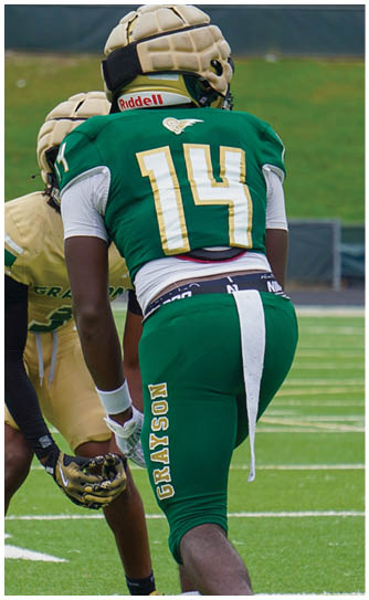 A football player catching a ball. Description generated by AI