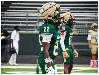 A group of football players on a field. Description generated by AI