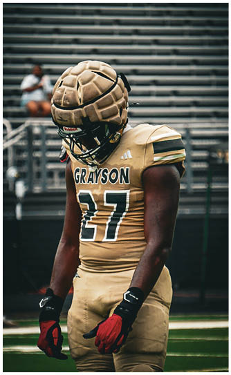 A football player catching a ball. Description generated by AI