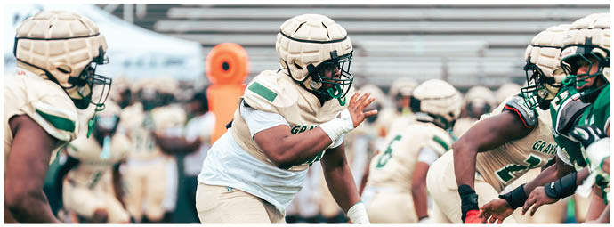 A football player wearing a blue and white uniform. Description generated by AI
