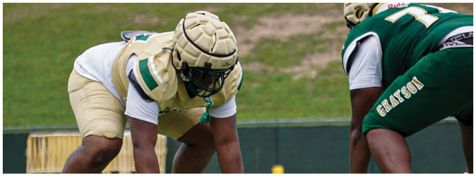 A football player wearing a blue and white uniform. Description generated by AI
