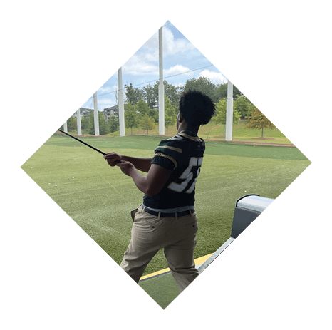 A football player wearing a black jersey with the number 3 kneels on the field. AI generated content