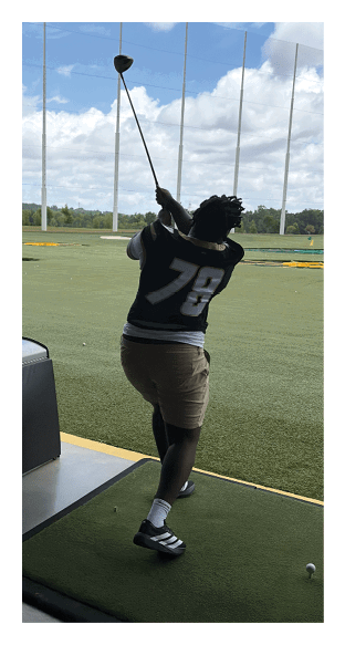 A man in a green shirt and black pants is preparing to throw a football. AI generated content