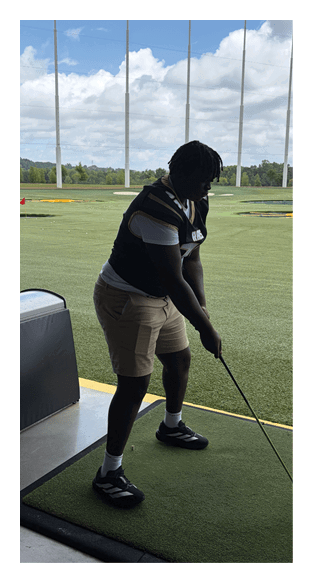 A football player is kneeling on the field, wearing a green jersey and a helmet. AI generated content