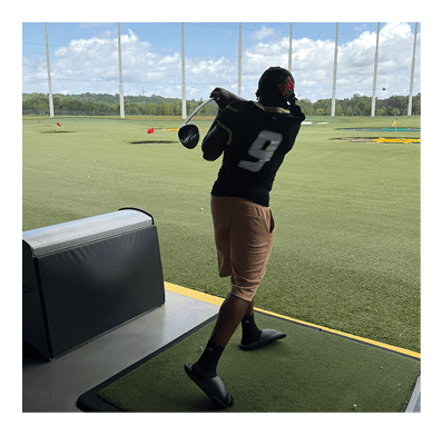 A football player in a white jersey with the number 85 on it is trying to catch a football. AI generated content