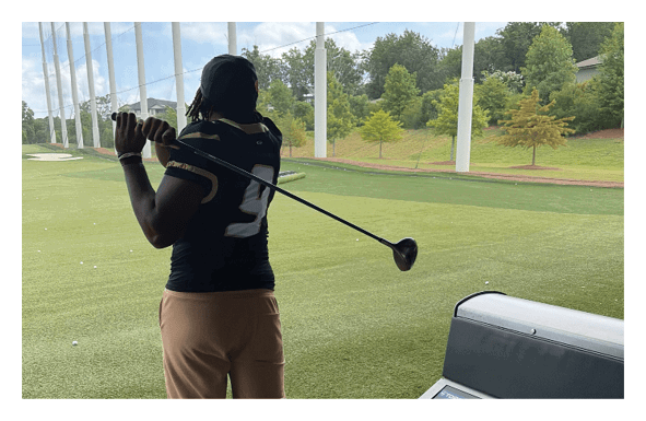 A group of football players wearing headphones and smiling. AI generated content
