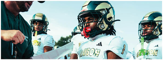 A football player wearing a blue and white uniform. Description generated by AI