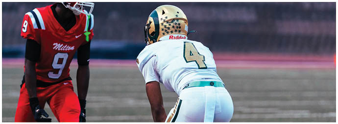 A football player wearing a blue and white uniform. Description generated by AI