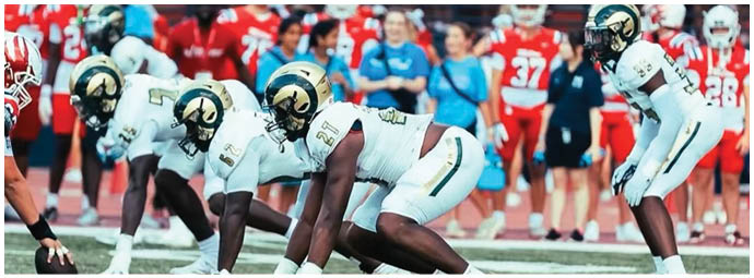 A football player wearing a blue and white uniform. Description generated by AI