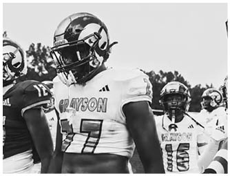A group of football players on a field. Description generated by AI