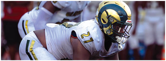 A football player wearing a blue and white uniform. Description generated by AI