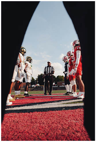 A football game is being played on a field. Description generated by AI