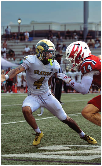 A football player catching a ball. Description generated by AI