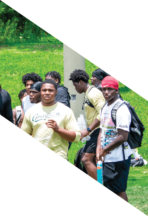 A group of young men wearing black and white uniforms are standing on a field. AI generated content