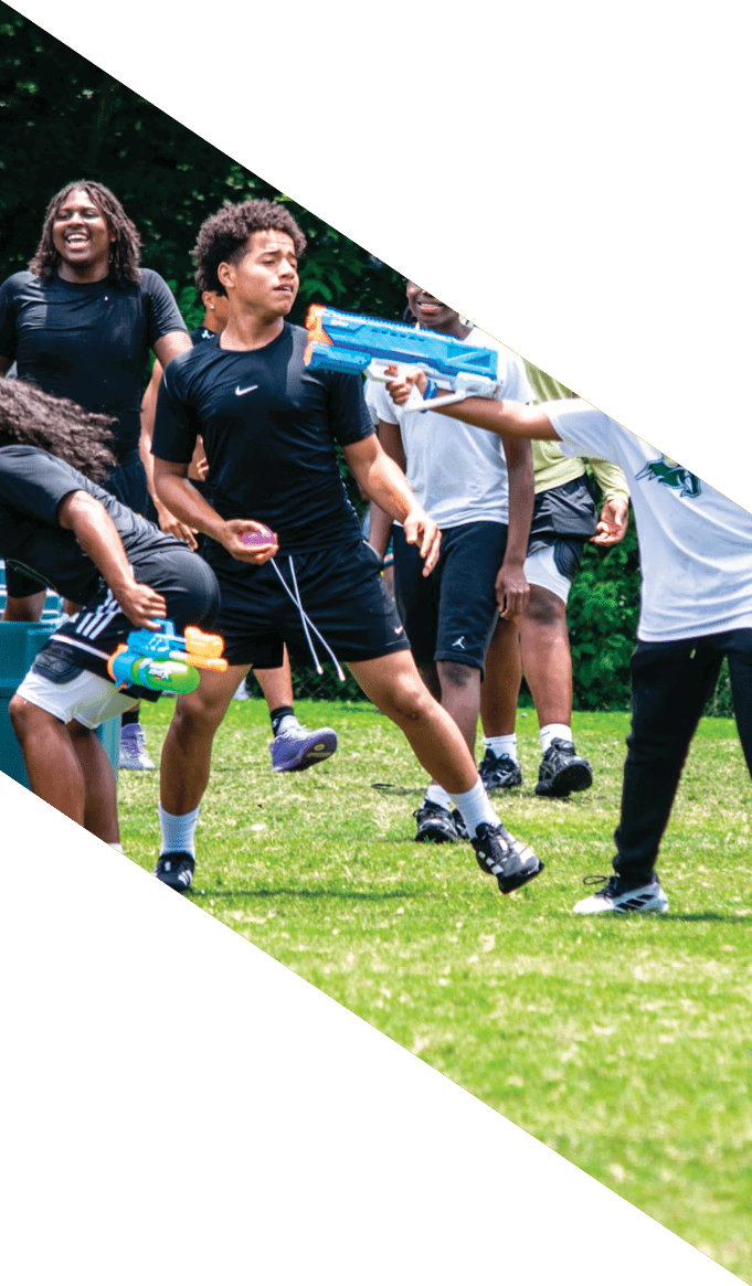 A group of people wearing black jerseys are huddled together on a field. AI generated content