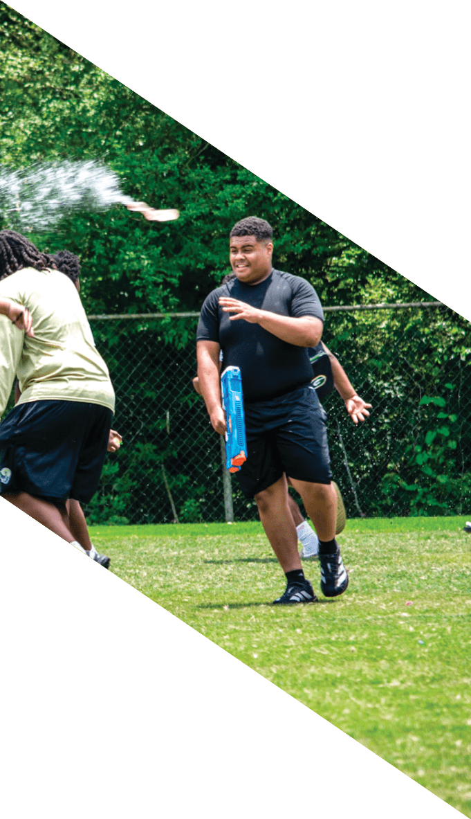 A football team is gathered around a coach, listening to his instructions. AI generated content