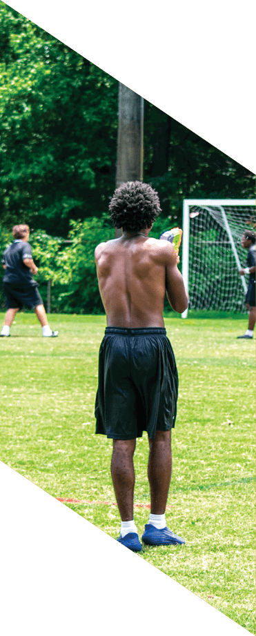 A football player wearing a white jersey with the number 86 catches a football in the air. AI generated content
