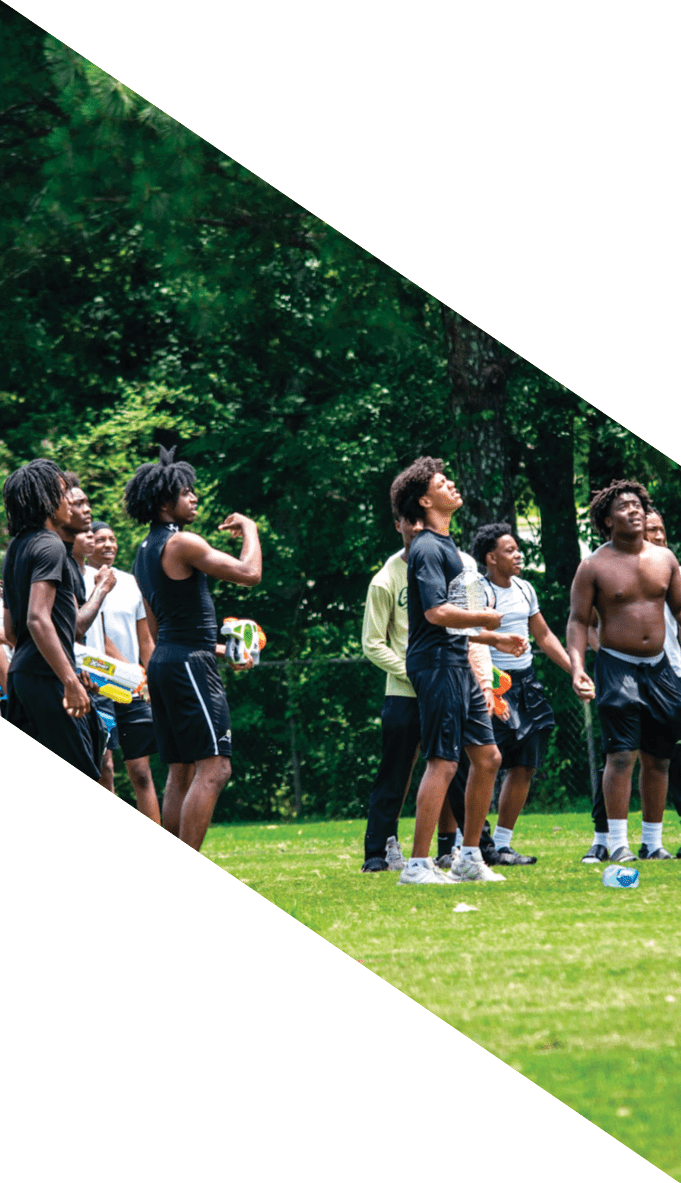 A football team is gathered around a coach, listening to his instructions. AI generated content
